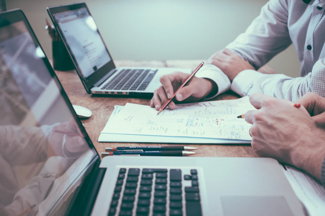 Colleagues reviewing financial planning notes and charts together at a desk