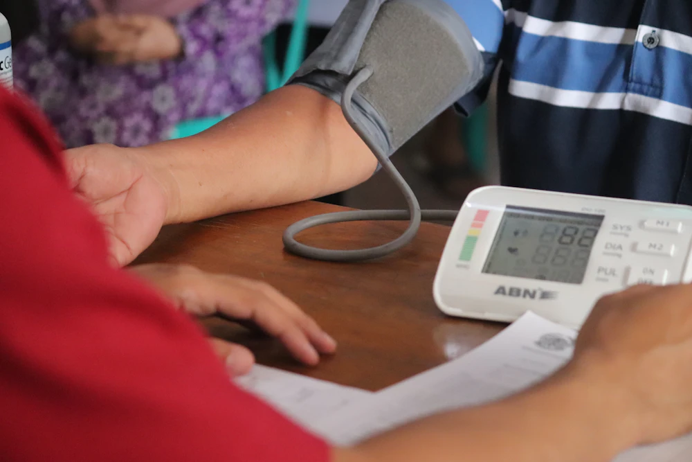 Digital blood pressure monitor on a table during a health check