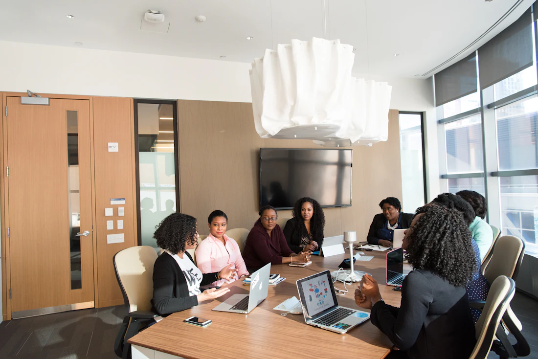 Diverse group of women in a professional boardroom discussion