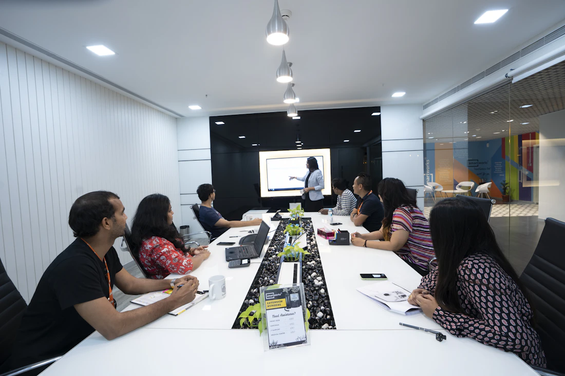 Indian corporate team in a conference room watching a colleague present